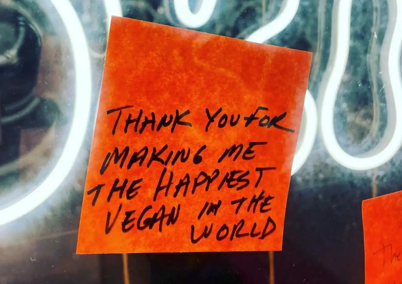 Red post-it with the text "Thank you for making me the happiest vegan in the world."